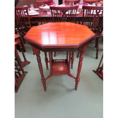 450 - An Edwardian mahogany octagonal occasional table on turned legs and castors with fretwork under tier... 