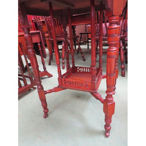 450 - An Edwardian mahogany octagonal occasional table on turned legs and castors with fretwork under tier... 