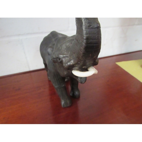 1131 - A vintage leather figure of an elephant, 33cm high