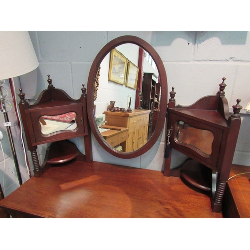 1048 - An Arts & Crafts walnut dressing chest in the manner of William Birch, the oval tilt mirror on mirro... 