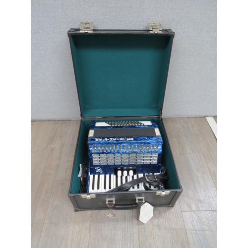 1067 - A Weltmeister 60 bass accordion model 3060II3 MT in pearlescent blue, with tags and fitted case