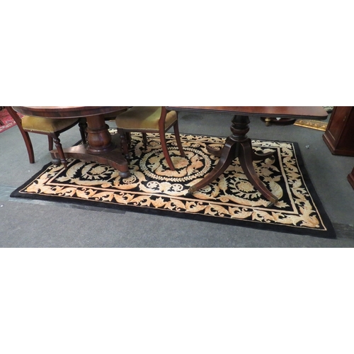 1022 - A large Chinese black and gold rug, 244cm x 153cm