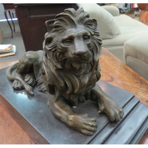 1171 - A cast bronze desk top lion on marble plinth, signed Barye, 31cm long