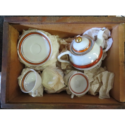 1310 - A miniature dolls tea set in original wooden box