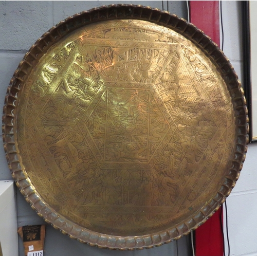 1311 - A large brass tray of Eastern design, 65cm diameter   (R) £25