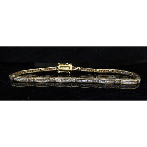 5081 - A gold diamond line bracelet, unmarked, 19cm long, 11.9g