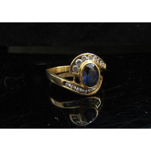 5082 - A sapphire and clear stone dress ring, stamped AU750. Size S, 3.7g