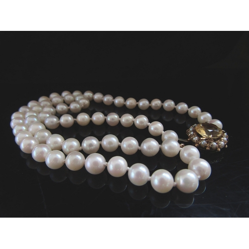 5087 - A single strand pearl necklace, 5mm pearls, 46cm long with a 9ct gold pearl and citrine set clasp