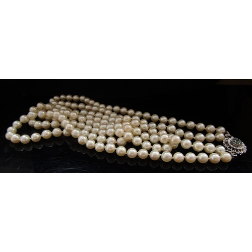 5088 - A double strand pearl necklace, 6mm pearls, 60cm long with an 18ct white gold emerald set clasp