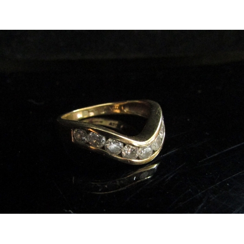 5099 - A 9ct gold diamond set wishbone ring. Size O, 3.2g