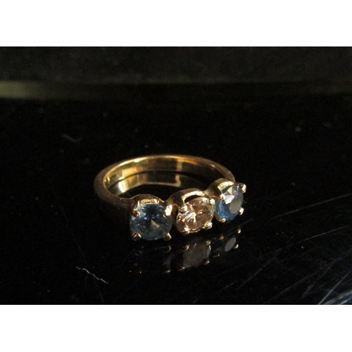 5100 - A diamond and sapphire three stone ring, 0.50ct diamond flanked by 0.50ct sapphires, unmarked. Size ... 