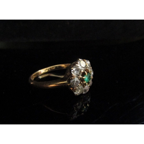 5102 - A gold ring, centrally set with an emerald framed by diamonds, stamped 18ct. Size O, 3.5g   (R) £300