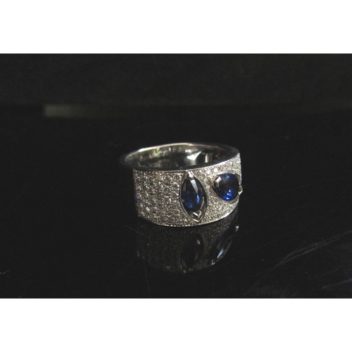 5106 - A modernistic 18ct white gold sapphire and diamond ring. Size N/O, 8.8g