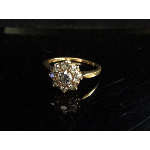 5107 - A diamond daisy ring, unmarked shank. Size M, 3.7g      (R) £300