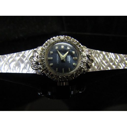 5112 - An 18ct white gold Bucherer lady's wristwatch, brick link strap and diamond set bezel, 26.2g   (C)