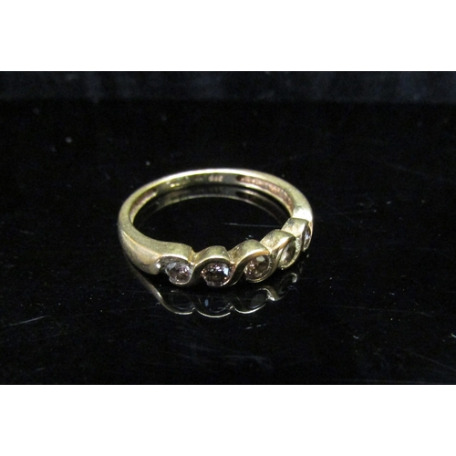 5116 - A 9ct gold ring set with five small diamonds. Size M/N, 1.8g   (C)