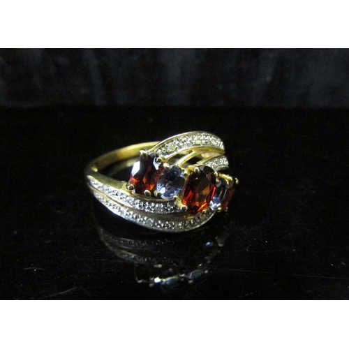 5117 - A garnet, sapphire and diamond chip dress ring, stamped 375. Size Q, 2.8g  (C)