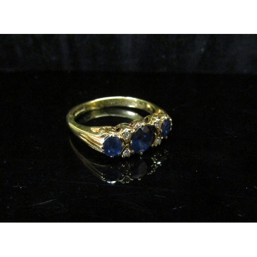 5119 - An 18ct gold sapphire and diamond ring. Size L, 3g