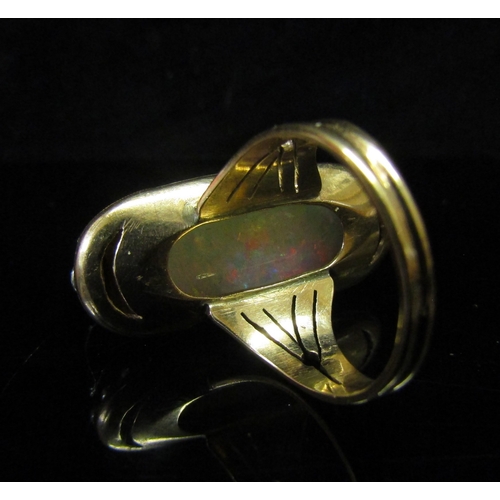 5186 - An opal and diamond ring, the central oval cabochon opal 23mm x 12.4mm x 5.77mm, estimated weight 9.... 