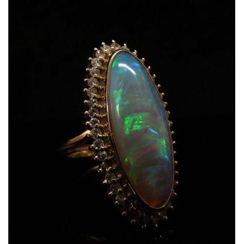 5187 - An opal and diamond ring the central oval opal 26.9mm x 10.4mm x 5.4mm, estimated weight 8.87ct fram... 