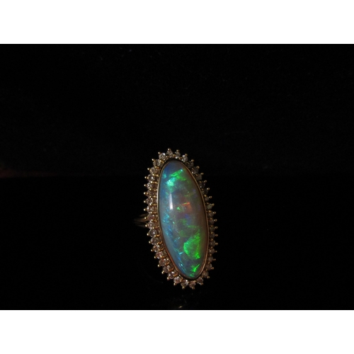 5187 - An opal and diamond ring the central oval opal 26.9mm x 10.4mm x 5.4mm, estimated weight 8.87ct fram... 