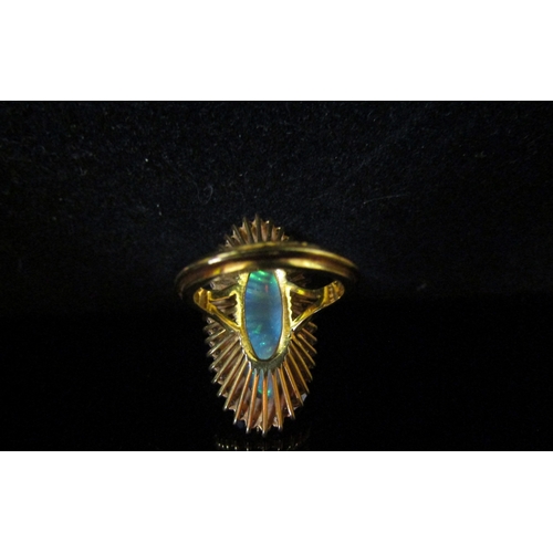 5187 - An opal and diamond ring the central oval opal 26.9mm x 10.4mm x 5.4mm, estimated weight 8.87ct fram... 