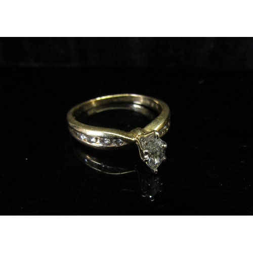 5125 - A gold ring with central marquis cut diamond and diamond set shoulders, stamped 14k. Size N/O, 2.9g ... 