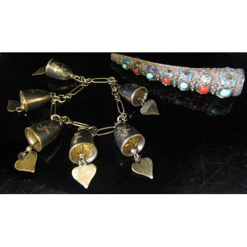 5130 - A Neillo silver charm bracelet hung with silver bell and heart charms with a Thai dancers silver fin... 