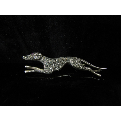 5131 - A rose cut diamond encrusted greyhound brooch with ruby set eye, set in yellow and white precious me... 