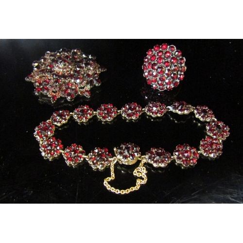 5138 - A demi parure of Victorian bohemian garnet jewellery including large cluster ring, daisy cluster pan... 