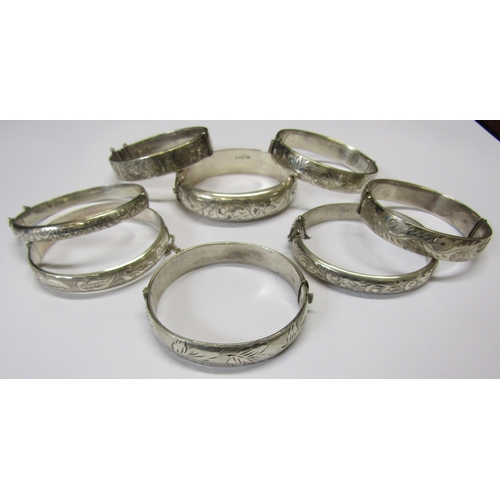 5139 - Eight silver stiff hinge bangles all with engraved decoration