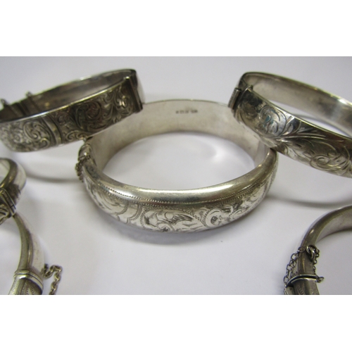 5139 - Eight silver stiff hinge bangles all with engraved decoration