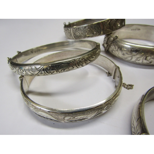 5139 - Eight silver stiff hinge bangles all with engraved decoration