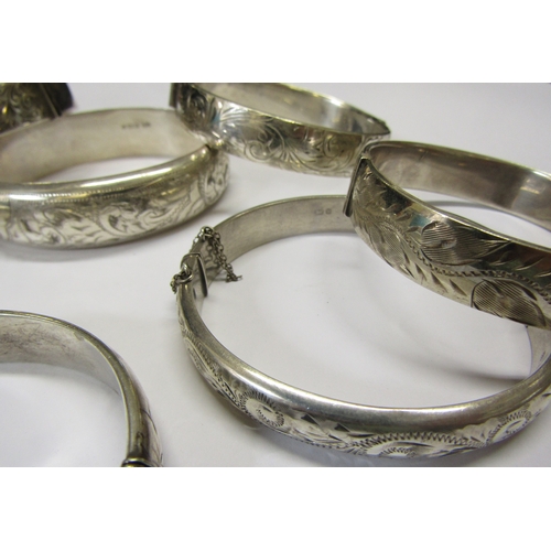 5139 - Eight silver stiff hinge bangles all with engraved decoration