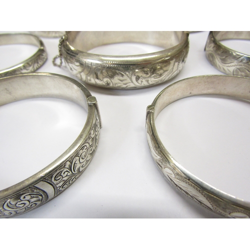 5139 - Eight silver stiff hinge bangles all with engraved decoration