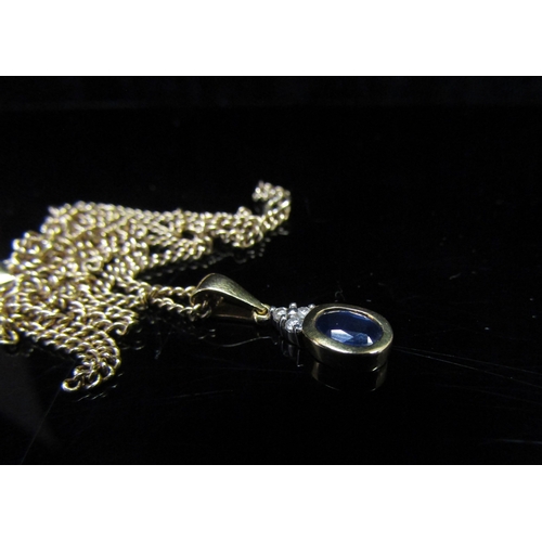 5141 - An 18ct gold sapphire and diamond pendant hung on a 9ct gold chain, 50cm long, 4.7g   (R) £60