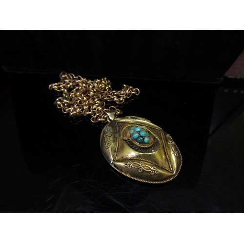 5150 - A gold belcher chain stamped 9ct, 60cm long, 14.5g hung with a Victorian oval locket with turquoise ... 