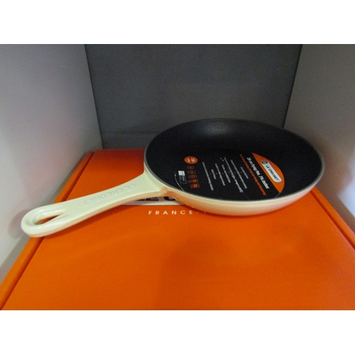 1268 - A boxed Le Creuset omlette pan in cream, 20cm