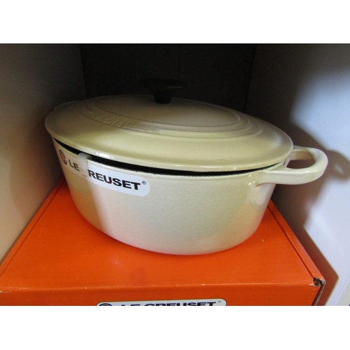 1272 - A boxed Le Creuset oval casserole/ oven dish and lid in cream, 27cm