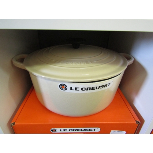 1273 - A boxed Le Creuset round casserole dish and lid in cream, 26cm