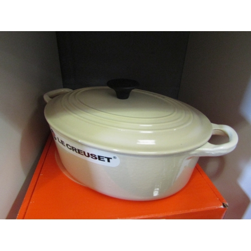 1275 - A boxed Le Creuset oval oven casserole dish and lid in cream, 23cm