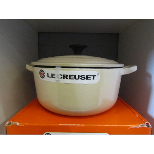 1276 - A boxed Le Creuset round casserole dish and lid in cream, 20cm