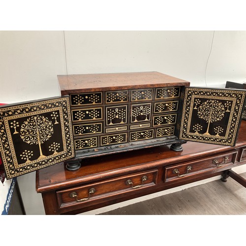 8022 - An 18th Century walnut collector's cabinet, the herringbone inlaid outer case with two doors opening... 