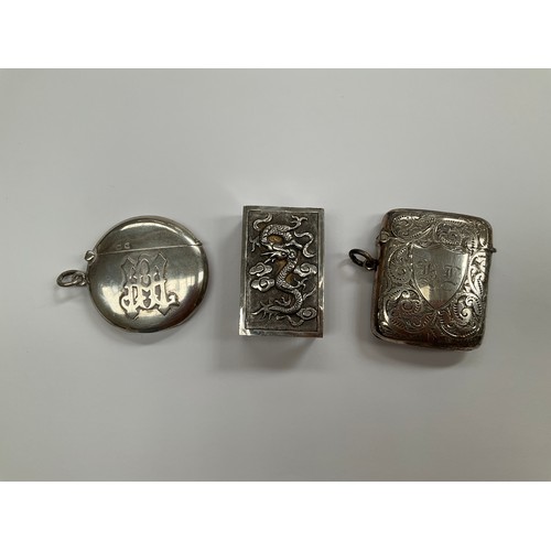 8081 - Two silver Vesta cases including foliate engraved and monogrammed circular example and a Chinese sil... 