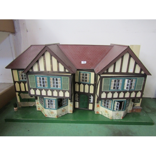 7063 - A large 1930's Tri-ang two storey dolls house with lighting, containing a collection of assorted fur... 