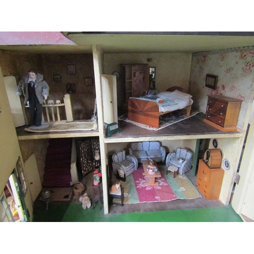 7063 - A large 1930's Tri-ang two storey dolls house with lighting, containing a collection of assorted fur... 