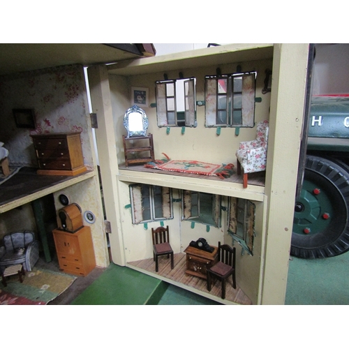 7063 - A large 1930's Tri-ang two storey dolls house with lighting, containing a collection of assorted fur... 