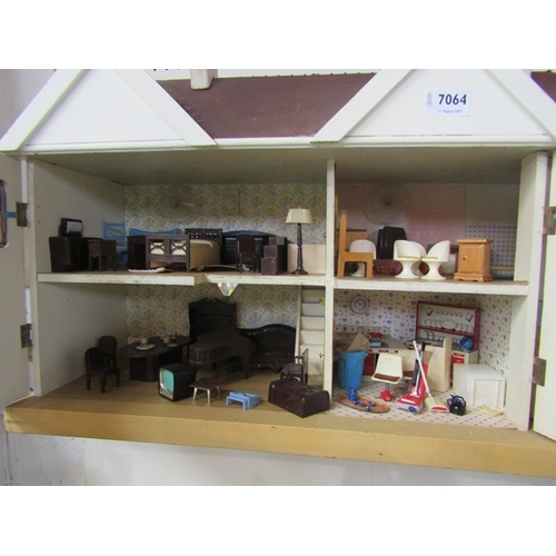 7064 - A 1950's Tri-ang two storey dolls house with garage, furnished with vintage plastic furniture includ... 