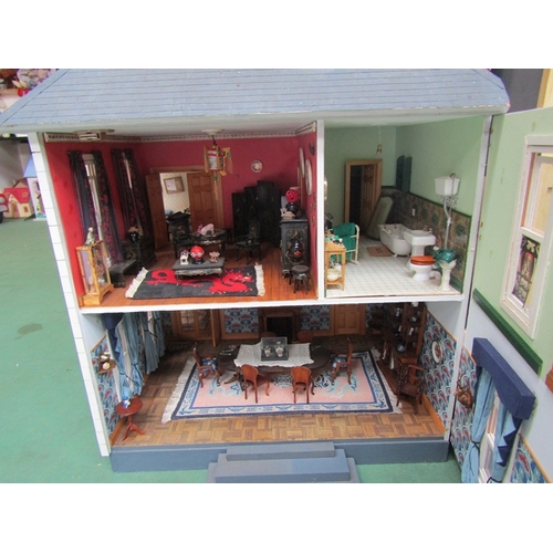 7068 - A large American kit built two storey dolls house with attic above, furnished with a good collection... 