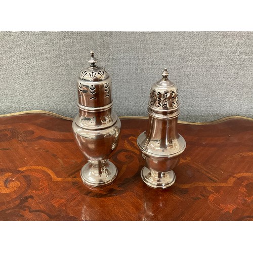 8162 - Two silver sugar castors, dented, 18cm tall and 16.5cm tall. Total weight 191g